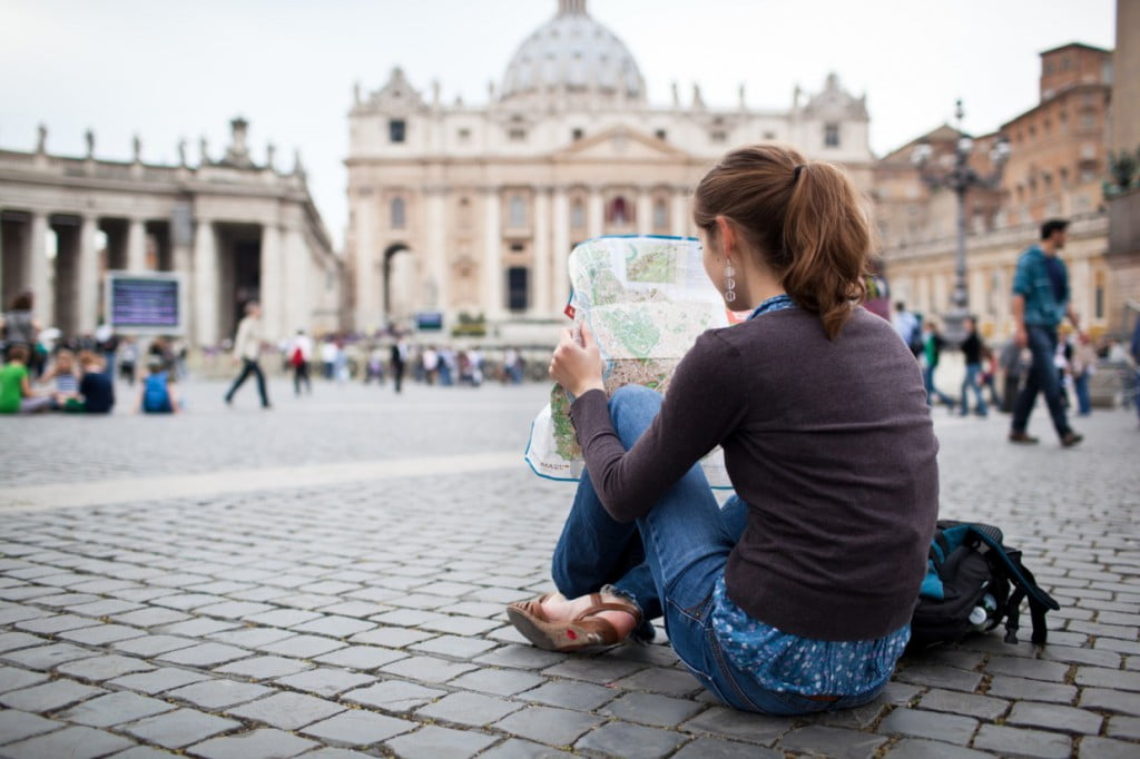 How to backpack through Italy in 15 days on a budget 23 Credits by lightpoet, Pretty young female tourist studying a map in Italy