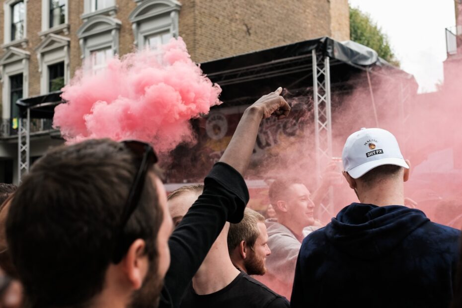 people near pink smoke