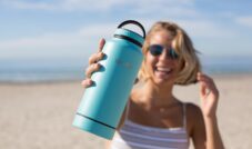 woman holding blue tumbler